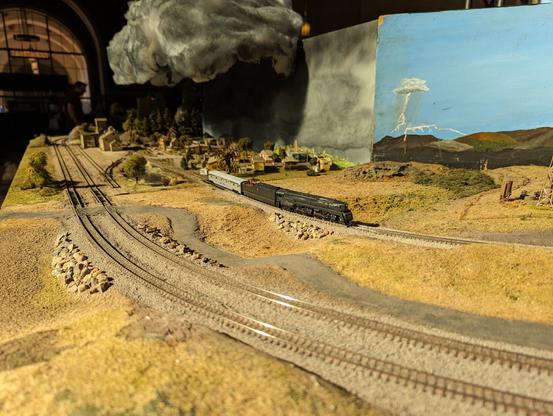 A sunlit view of a steam locomotive rounding the corner