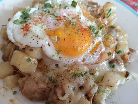Potatoes, bacon, mushrooms, and broiled cheese, topped with a fried egg #Breakfast #Brunch