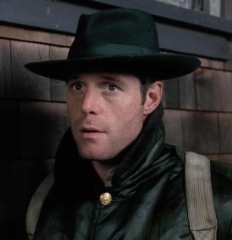 Ranger Moore in The X-Files season 1 episode “Darkness Falls”, wearing a satiny jacket with brass buttons, a backpack, and a bottle green fedora with snapped-up brim and a classy ribbon. They didn’t even put insignia on the hat.