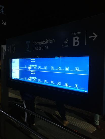 Full board displaying the start menu with 2 trains announcements with platform positions indicated by letters, the background is blue