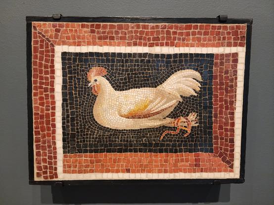 small mosaic of a bound white rooster against a black background. around the black area is a white border and a thicker red border.