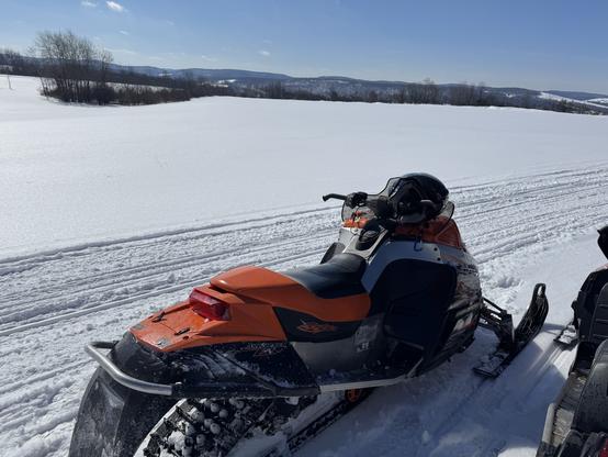My ArcticCat F6 snowmobile on the side of the trail overlooking the hills