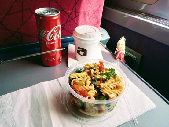 Finger puppet enjoying vegetarian pasta, coke and coffee.