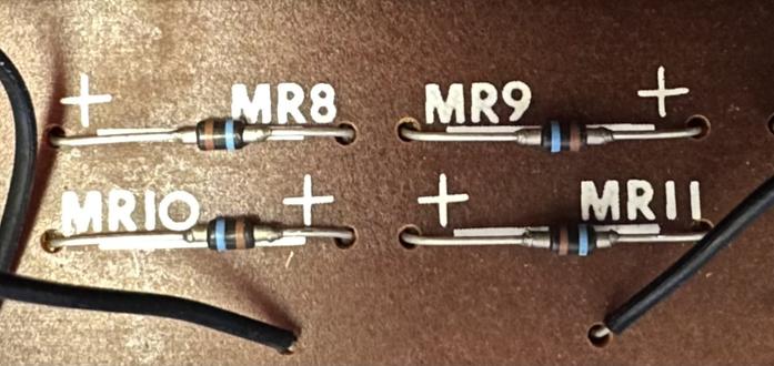 A brown pcb with 4 small diodes labelled MR8 to MR11, clearly arranged as a bridge rectifier. The diodes are marked with brown and blue stripes.