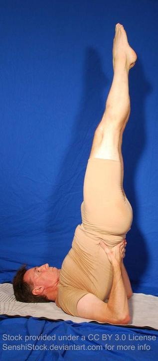 A white man backwards onto his neck and shoulders, legs extended into the air.