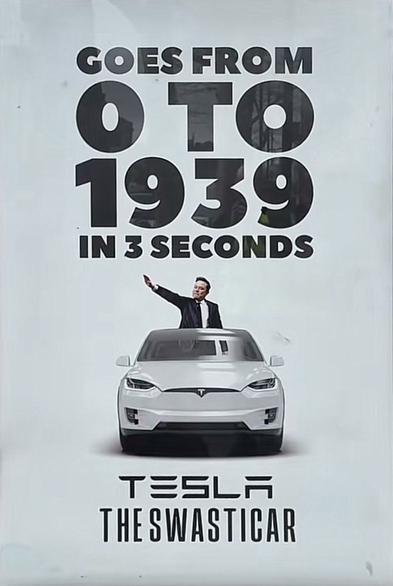 A white Tesla. Behind it, Elon Musk is flashing a Nazi salute

Above, the words:
"Goes from 
0 to 1939
in 3 seconds"

Below, the words: 
"TESLA
The Swasticar"
