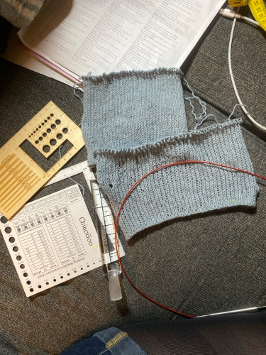 Two blue gray knit swatches, and various gauge measuring tools. Patons Linen in Sky