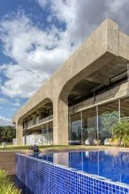 The blue tiled pool contrasting with the long, wide lines of concrete.