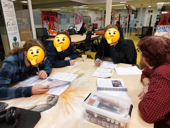 One teacher guiding three students through how to create a frostgrave warband. They are chewing pencils and scratching their chins