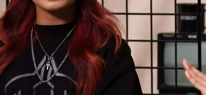 Person wearing a couple of necklaces including a Chrome Hearts dagger pendant