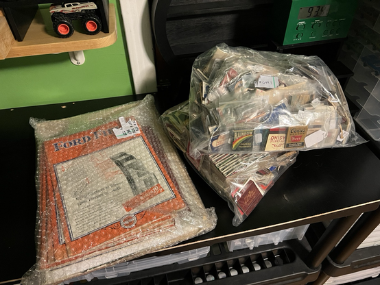 Packages full of vintage automotive books and advertising.