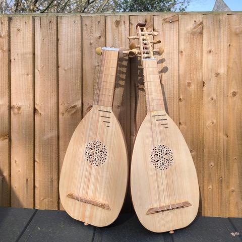 A matching pair of soprano lute and renaissance mandore I built recently for a customer, photographed together outside in the sunshine.