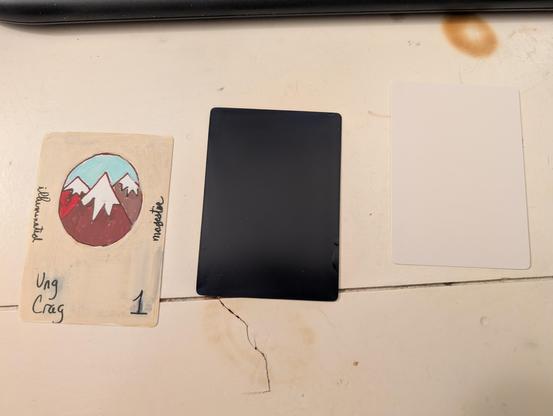 Blank white card; midnight blue card back; original hand-drawn card front attempt.