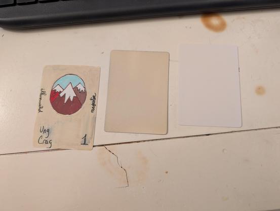 Blank white card; parchment card front; original hand-drawn card front attempt.