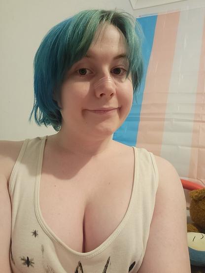 Revy wearing a singlet & no makeup
Her chest be looking big
A trans flag in background