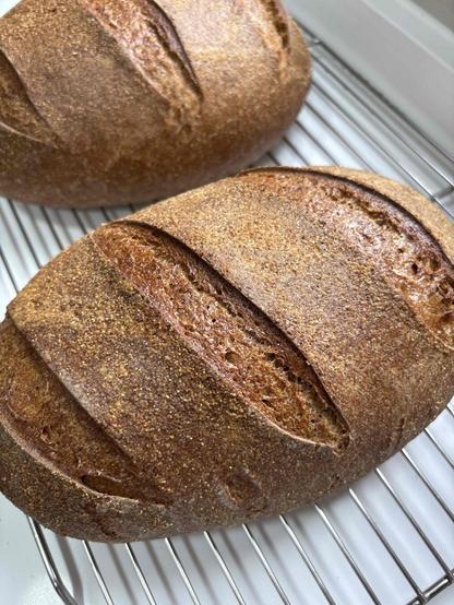 2 bread loaves on a cooling rack