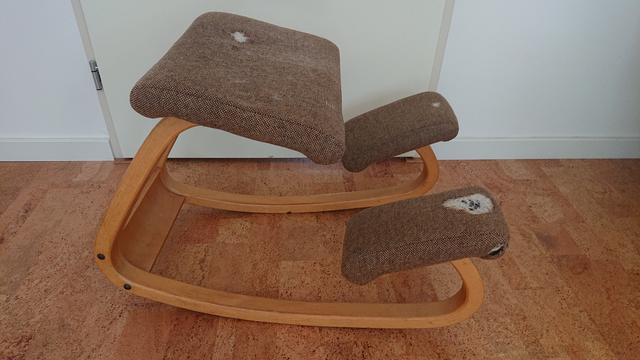 Kneeling chair, boring beige fabric with huge holes in it