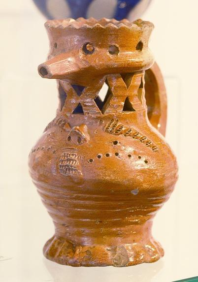 A similar jug like the brown one, but this one is complete with openwork neck, spout and handle.