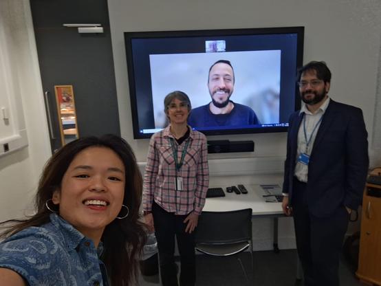 Fiona taking a selfie with examiners Matishalin Patel and Gal Eyal on a screen via Zoom and chair Africa Gomez.