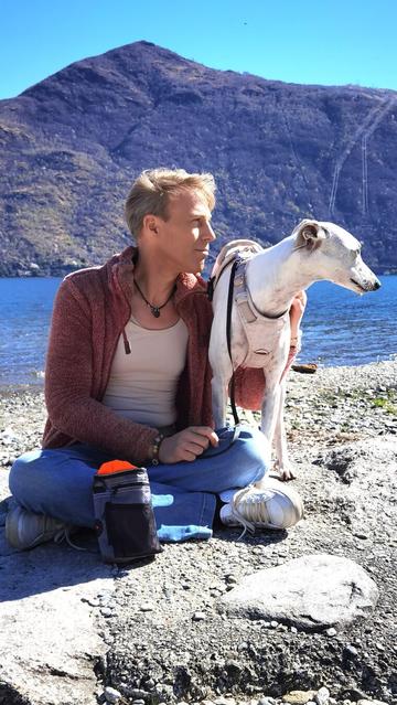 Ich sitze mit meinem Hund am Wasser