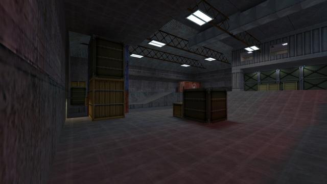 In this picture you can see the warehouse from the inside. This is the view from the back entrance, which will be shown in the photo series. You can see several boxes, cointainers and ramps. In addition, you can see a kind of administration on the upper floor. In the background you can see a raised catwalk, which leads to the "Administration". Furthermore, white lights are attached to the ceiling of the warehouse, which are also illuminated. Between these you can also see a ventilation shaft. This is on the map cs_assault in the game Counter-Strike 1.6.