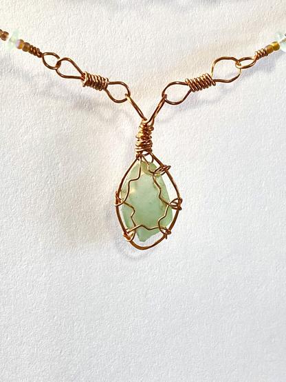 Aquamarine seaglass pendant wrapped in reclaimed copper wire on a custom wire wrapped necklace