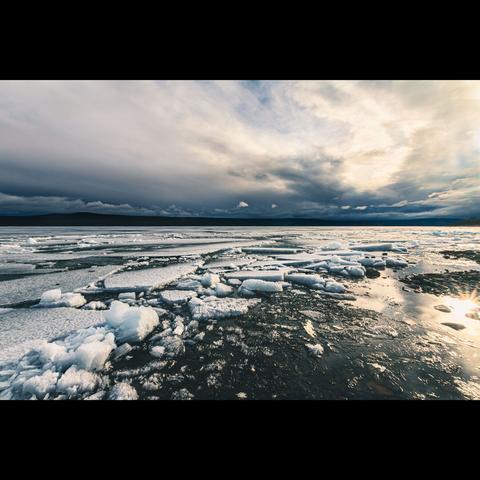 Frozen lake with sunset reflection , photography in color, Yukon territory, Canada