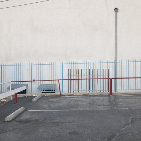 parking lot with red and blue fences