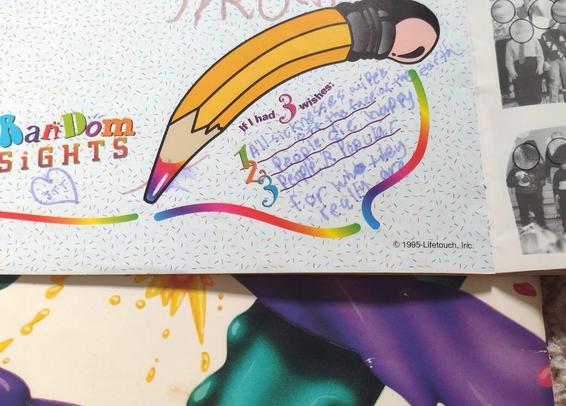 A colorful page from a 1996 elementary school yearbook. There are multiple fonts and fill-in-the-blank spaces for writing in “random insights.” A student’s sloppy handwriting fills the spaces in purple marker.