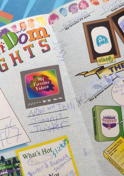 A colorful page with multiple fonts and fill-in-the-blank spaces, listing a student’s favorite videos, “what’s hot” and the greatest teacher. That name is obscured because you don’t need to know who I had a crush on when I was 11.