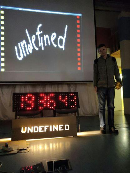 Nikhotmsk near his inventions, a big digital clock and a lightbox.