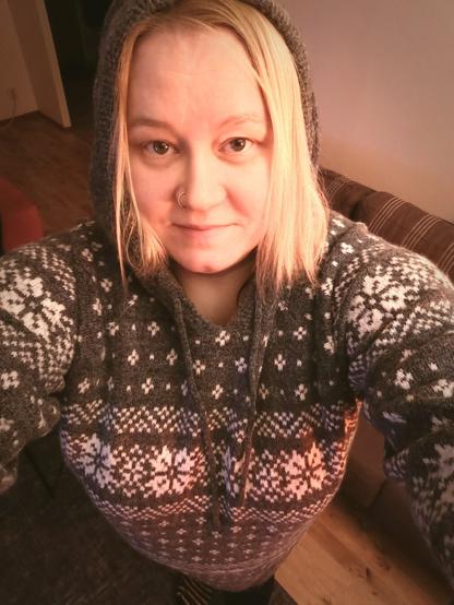 Woman looking up to The camera. Blondie hair, Grey hoodie on.