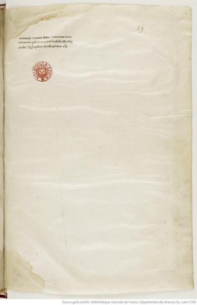 Yellowish manuscript page with three lines of writing in the top left, and a red library stamp just below.