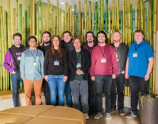 this is a group picture of Daniel Gruss and his nine PhD students. Daniel is in the middle of the group.