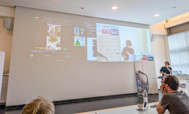 a photograph of Daniel Gruss giving a keynote at the RuhrSec conference