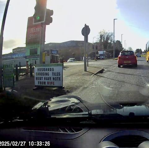 Roadside sign stating “Husbands choosing tiles must have note from wife”
