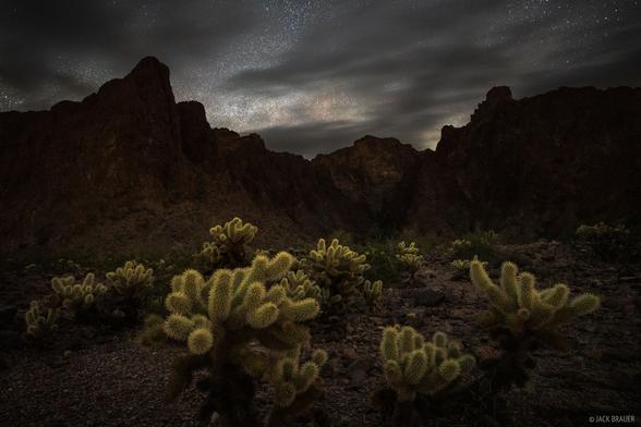 Stars over the Kofa Mountains of western Arizona. The landscape is illuminated solely by starlight, visible only with the camera's long exposure.