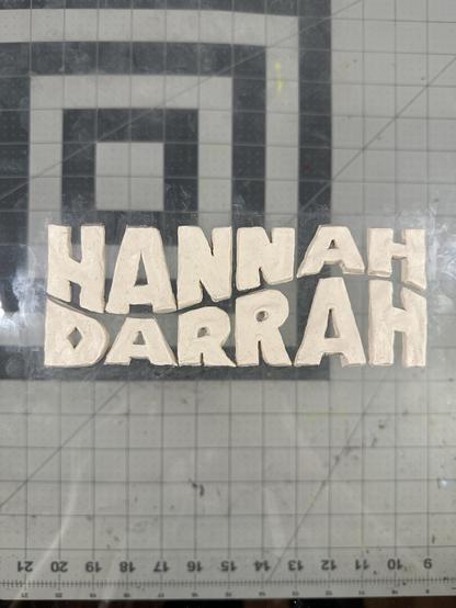 A claymation logo on a piece of plexiglass