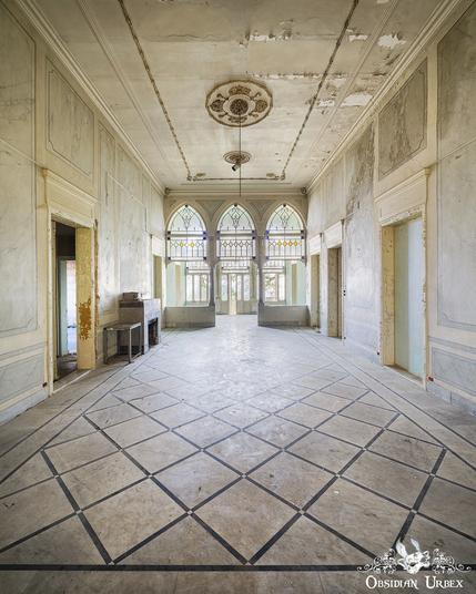 grand abandoned room in Ottoman style, with triple arch leading to balcony