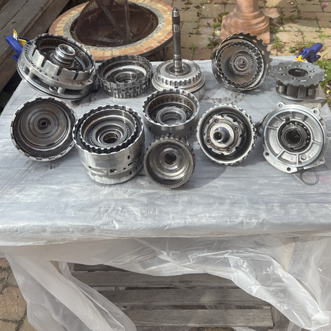 All of the clutch drums and ring gears and other moving parts have been removed from the ZF 5HP19 five-speed automatic transmission for my 2003 BMW 530i, and are arrayed on a small table covered with a plastic drop cloth. In all, there are 11 assemblies.