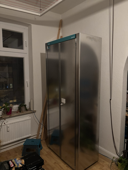 Big phone exchange rack. Doors and front side out of stainless steel. Above the doors is a label “EWSD SIEMENS” on Siemens typically turquoise backdrop.