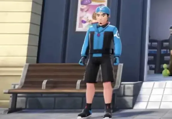 Screenshot from a Pokemon game showing a male looking character in blue and black clothes with black shorts and a helmet standing in front of a wooden bench.

The bench has two metal armrest-like separators commonly used in real life to prevent people from sleeping on benches.
