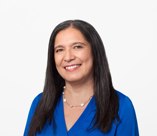 A portrait of Natasha Noy from Google. She is wearing a blue dress and is smiling towards the camera...