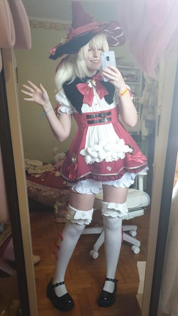 A selfie of a cosplayer of Klee in the skin Blossoming Starlight, standing in front of a mirror with a smile on her face and waving her right hand 

Tag ignore: cosplayer girl cosplaygirl blossoming Starlight Genshin impact kofi throne request commission Loli thighs thick thicc