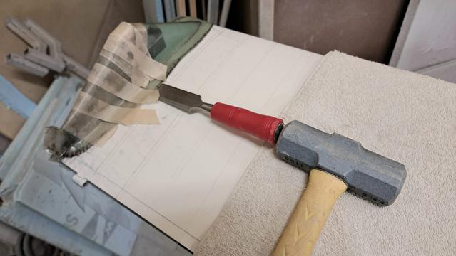 No! You risk damaging the wing's surface this way. (OK, you could use a plastic/rubber wedge, but let's try a finesse method first...)