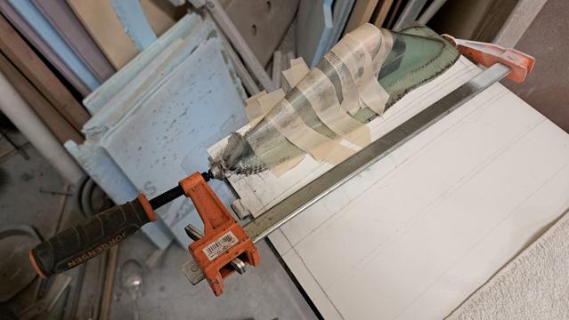 The long clamp squeezes on both ends of the fiberglass part...never touching the wing. This squeeze causes the base of the fiberglass part to bow outwards...shearing along the surface of the wing.