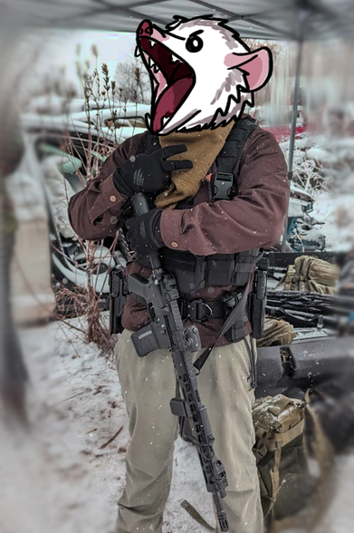 A person with a possum head holding a firearm in the snow