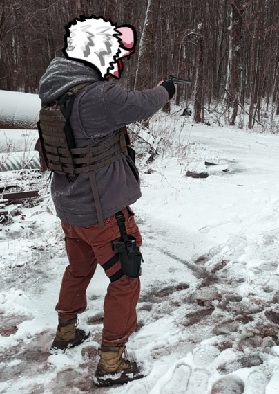 A person with a possum head holding a handgun in the snow