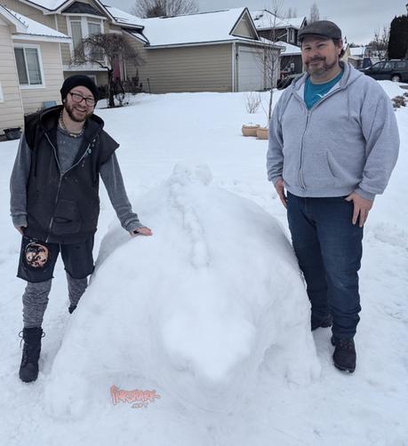 My partner and i standing on either side of the ankylosnowrus, which comes up almost to our waists and if it was real we could both ride it at the same time