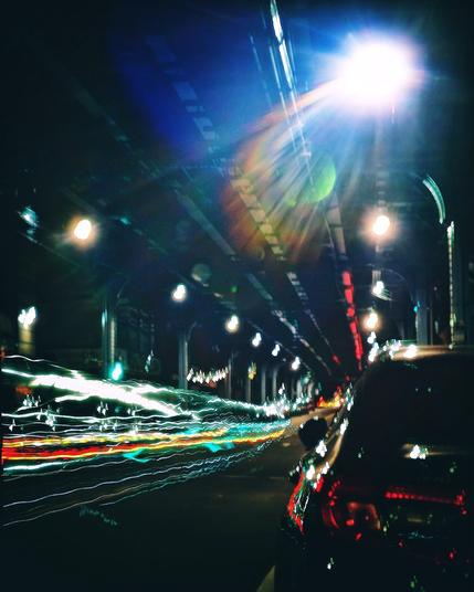 Light trails from a passing car in an urban setting.